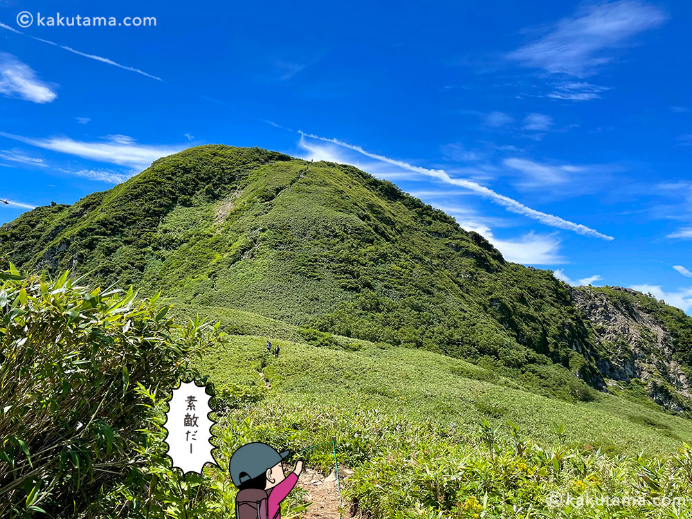 雨飾山山頂を見た写真と登山者のイラスト